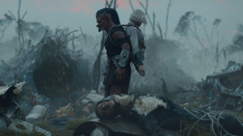 Dek et Thia errant sur un champ de bataille dans Predator : Badlands (2025)