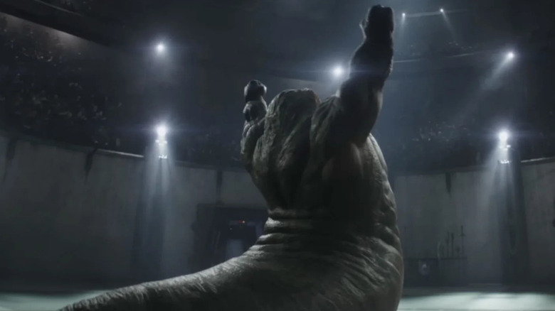 Un Hutt musclé levant les bras dans une arène de gladiateurs