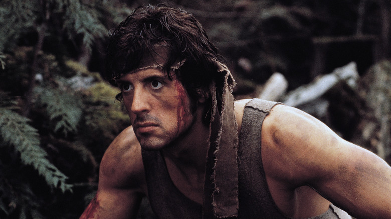 Rambo accroupi dans la forêt dans First Blood (1982)