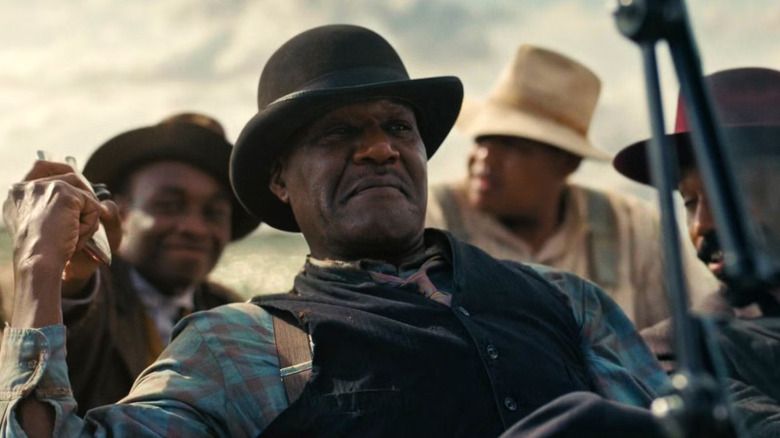 Delta Slim s'adossant dans la voiture dans Sinners