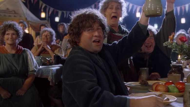 Les Hobbits applaudissent à la fête d'anniversaire de Bilbo dans La Communauté de l'Anneau