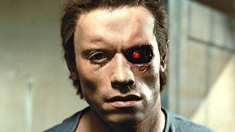 Le T-800 se regarde dans le miroir avec son œil rouge exposé dans The Terminator