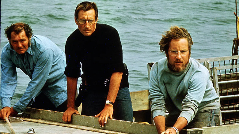 Hooper, Brody et Quint penchés sur le bord d'un bateau
