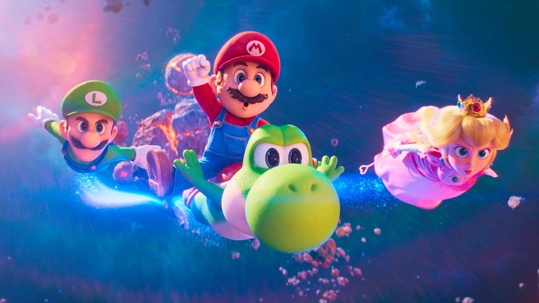 Luigi, Mario chevauchant Yoshi et Peach volent dans l'espace.
