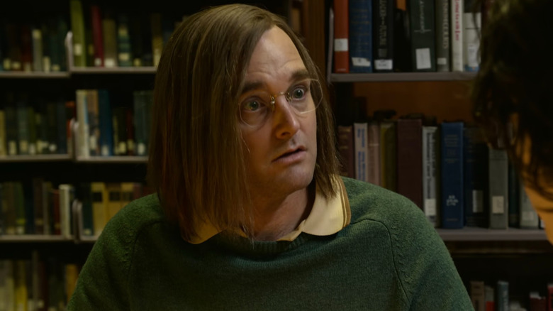 Douglas Kenney avec des livres derrière lui 