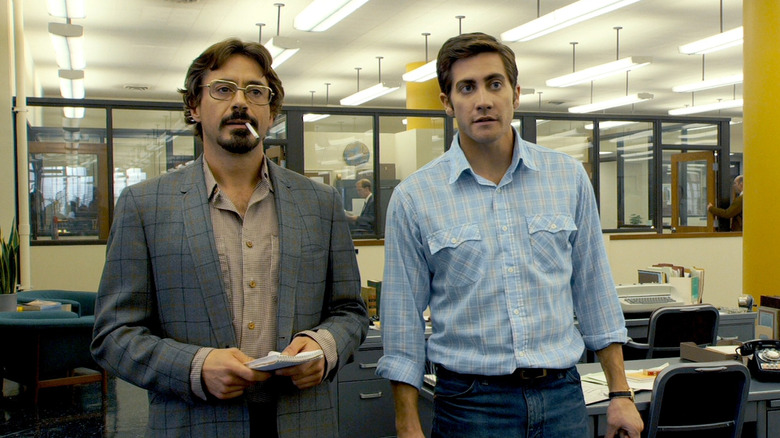 Robert Graysmith et Paul Avery discutant à un bureau 