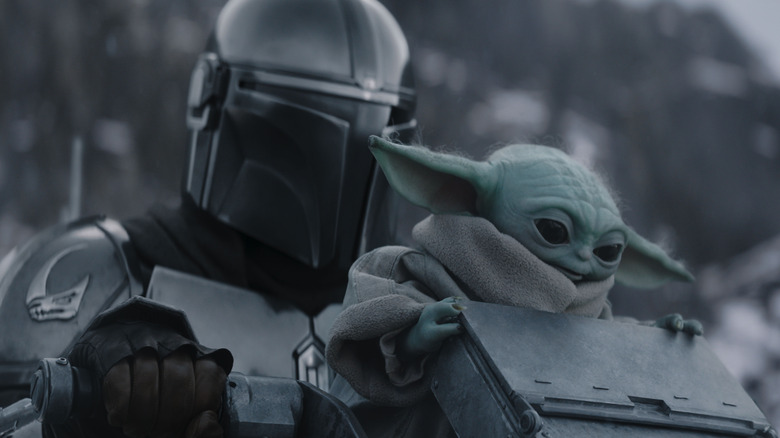 Din Djarin chevauchant un croiseur spatial avec Grogu dans The Mandalorian et Grogu
