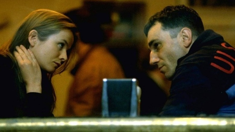 Maggie et Danny se regardent à travers une table de restaurant dans The Boxer (1997)