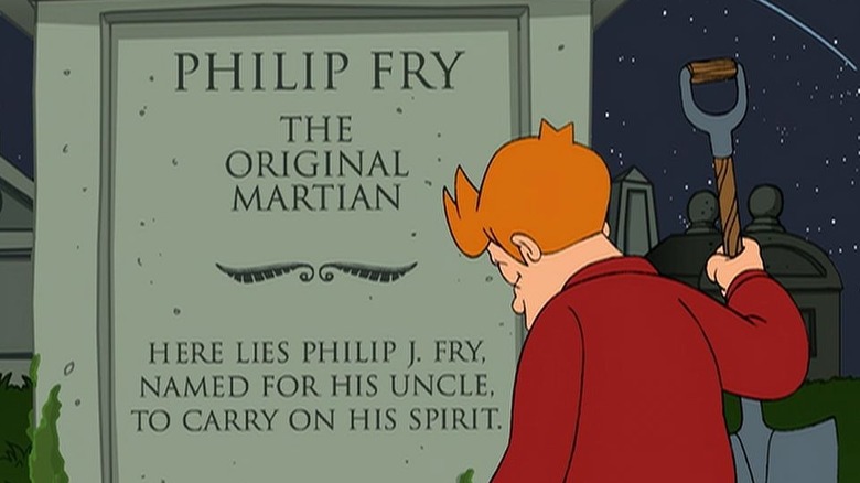 Fry, tenant une pelle, est assis devant la pierre tombale de son neveu, à "Futurama" (1999-présent)