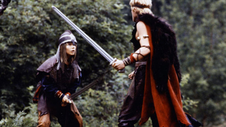 Sigurd, l'épée à la main, regardant un adulte brandissant l'épée dans The Littlest Viking (1989)