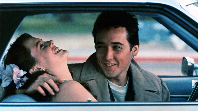 Lloyd avec ses bras autour d'une Diane qui rit dans une voiture