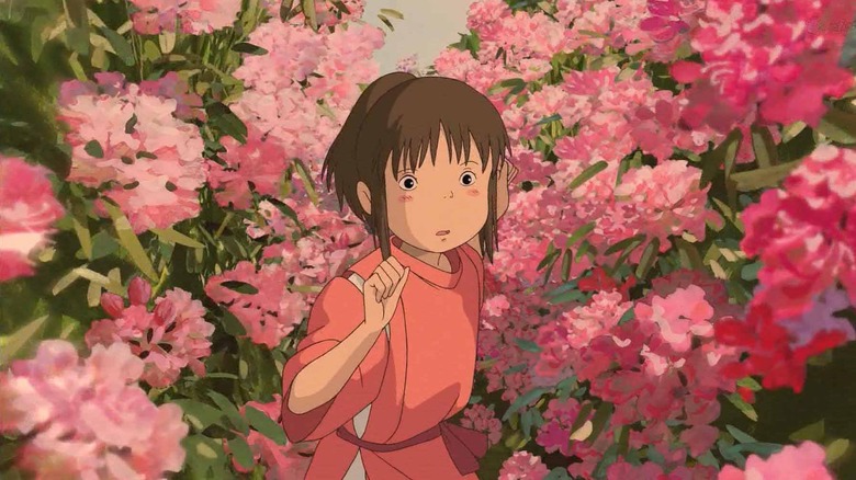 Chihiro courant à travers les fleurs dans Spirited Away (2001)