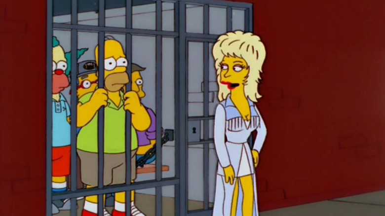 Dolly à côté d'une cellule de prison avec Homer dedans dans Les Simpsons