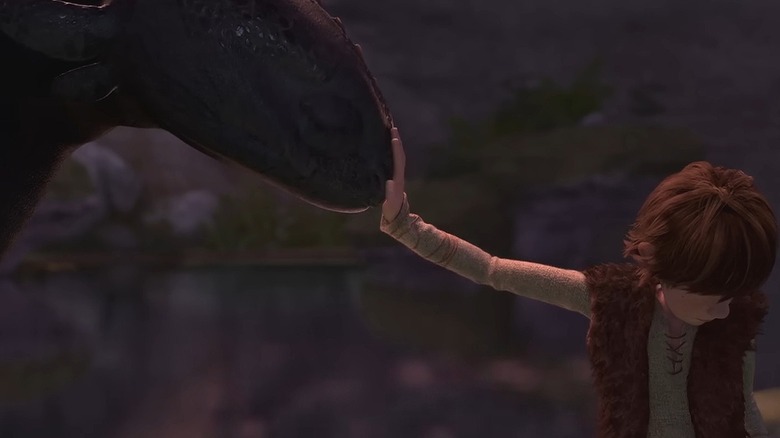 Krokmou donne un coup de tête contre la main de Harold dans Comment dresser votre dragon
