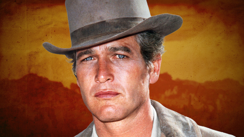 Paul Newman dans un chapeau de cowboy avec un fond orange