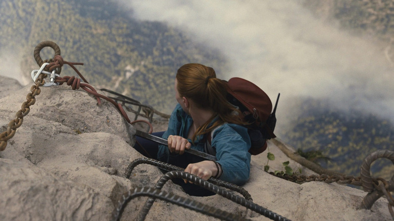 Jax gravissant une échelle sur une montagne dans Fall 2 : Deadpoint