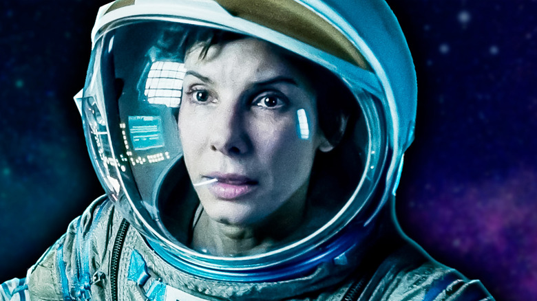 Gros plan de Sandra Bullock dans le rôle de Ryan Stone dans Gravity. Contexte de l'espace du film